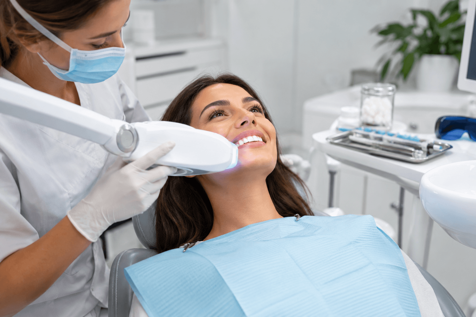 Dental professional providing a controlled teeth whitening treatment
