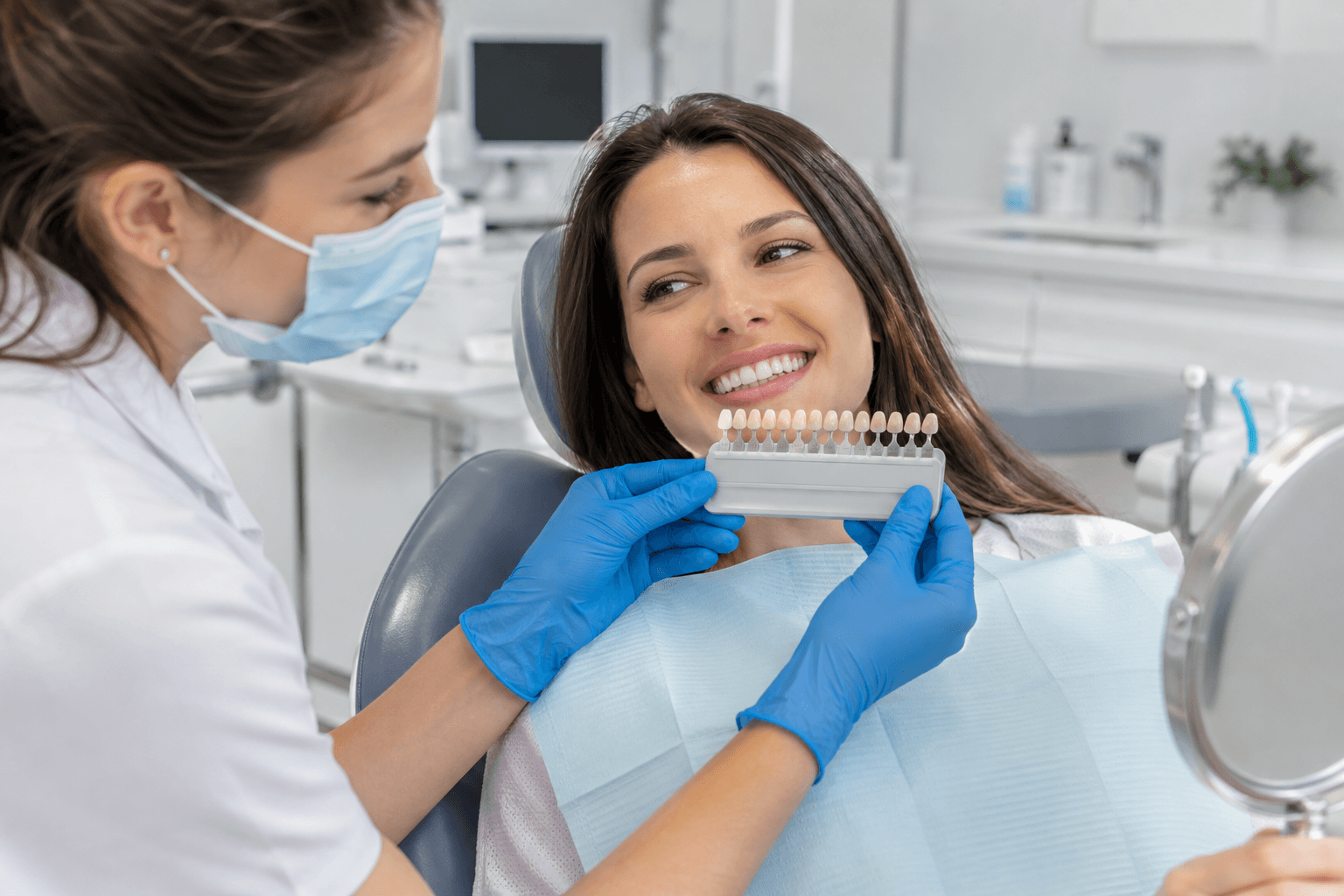 Dental professional comparing natural tooth shades for whitening results